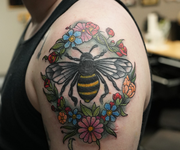 Bee tattoo after being restored and reworked