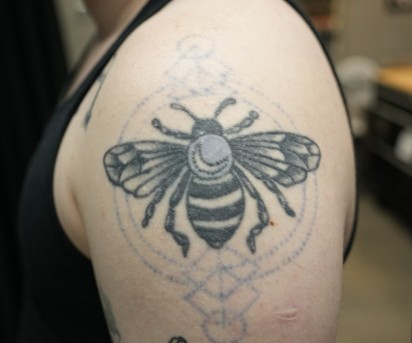 Bee and geometry tattoo before renovation