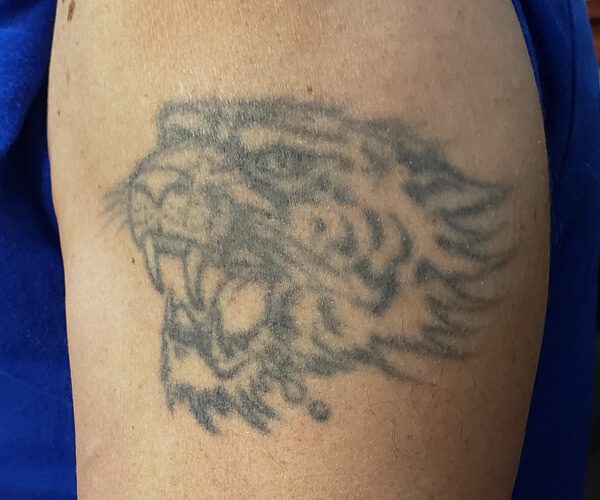 Aged tattoo of a tiger's face.