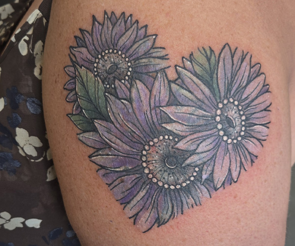 flowers in the shape of a heart showing the after state of this coverup tattoo