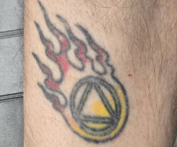 old and faded symbol tattoo showing before state of refreshed tattoo